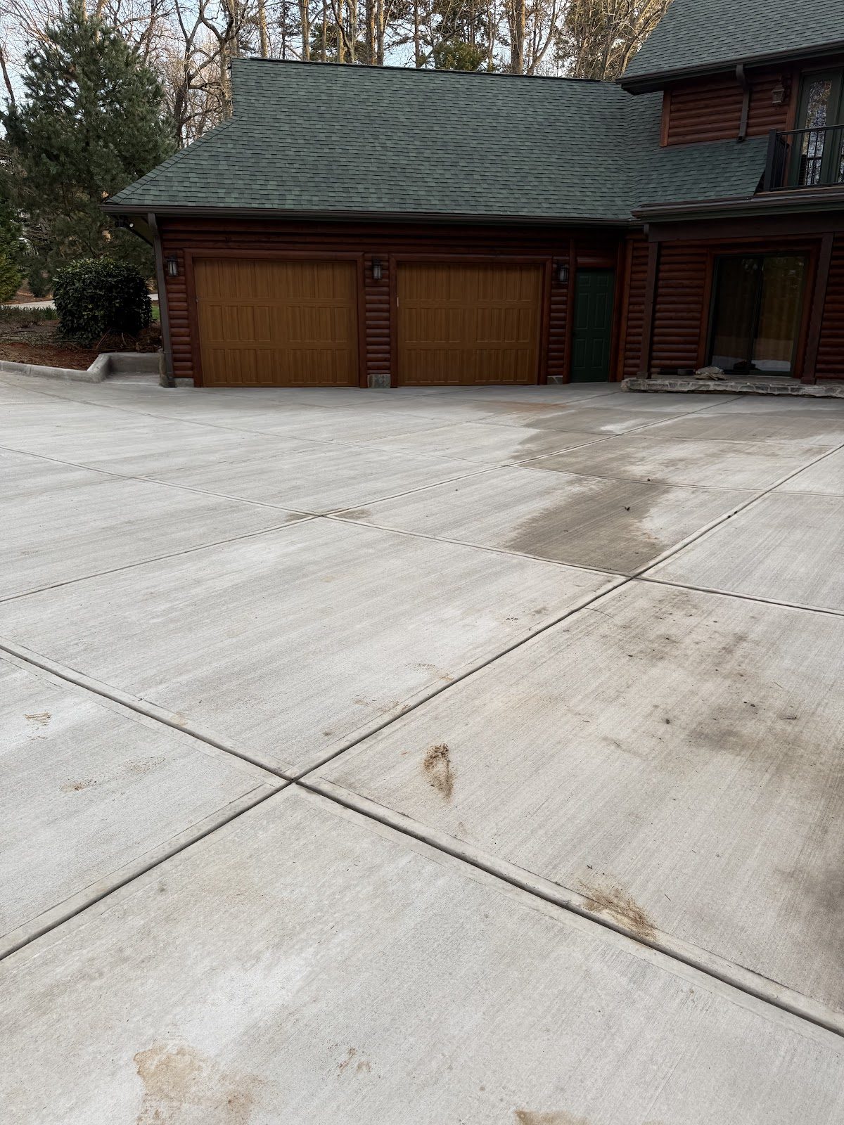 Broom-finish concrete driveway and garage apron at a log home