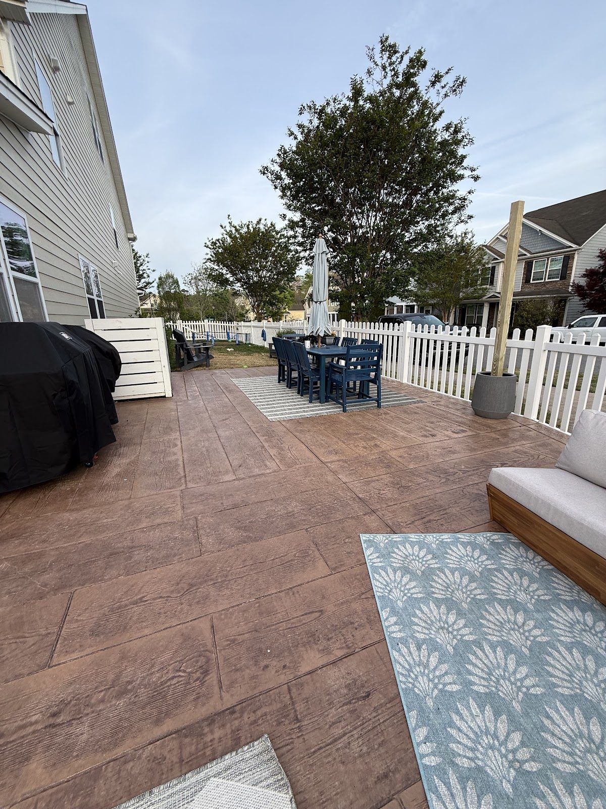 Stamped wood-plank concrete patio with an outdoor dining set